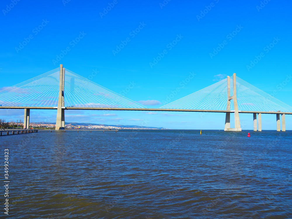 View of the Vasco da Gama Bridge and the Tagus River near the Park of the Nations (Parque das Nações) in Lisbon, Portugal. View of the Vasco da Gama Bridge and the Tagus River near the Park of the Nations (Parque das Nações) in Lisbon, Portugal.