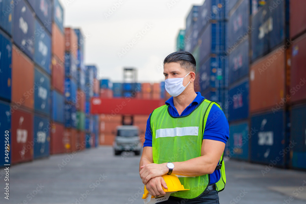 Cheerful factory worker man holding hard hat and looking forward, Happiness engineer at containers cargo concept Cheerful factory worker man holding hard hat and looking forward, Happiness engineer at containers cargo concept