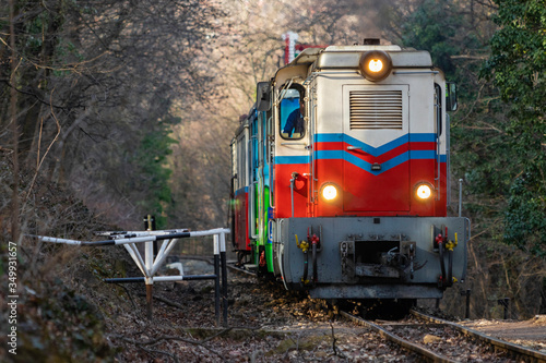Train is climbing a hill in Huvosvolgy-Budapest on a cold day in February, operated by children
