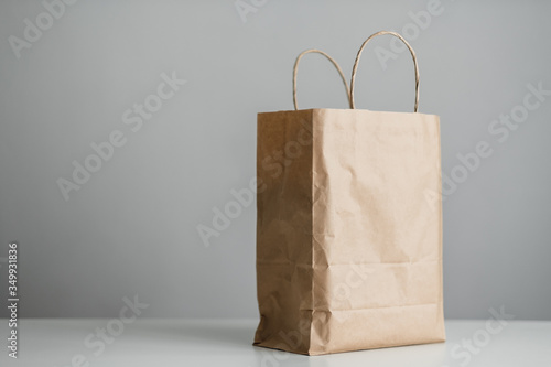 Craft eco pack on white table, gray background, mock up. Delivery concept