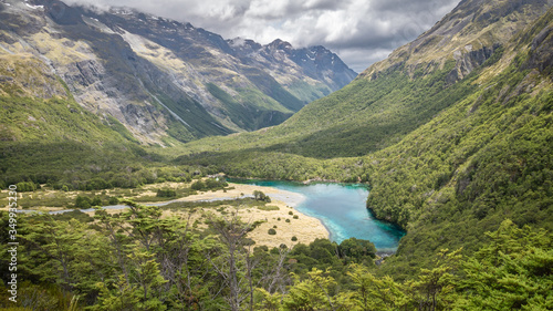 Pristine alpine lake hidden in the mountain valley, shot at Blue Lake, Nelson Lakes National Park, New Zealand photo