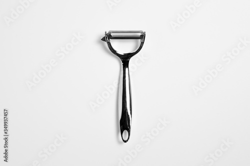 Stainless steel Peeler isolated on white background. Knife for potato. Kitchenware. High-resolution photo.