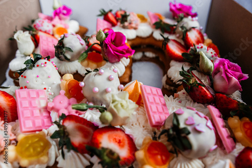 Beautiful fruit cake decoration. strawberries and flowers