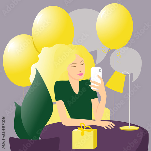 Young girl holding a white smartphone in her hands. A blonde woman with yellow balloons behind her, maybe it's her birthday. The concept of social networks, internet communication, virtual dating.