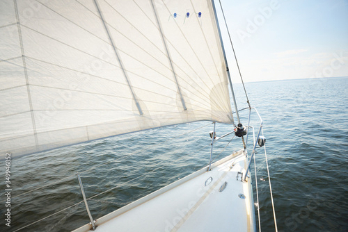 Tableau sur toile White yacht sailing on a sunny summer day