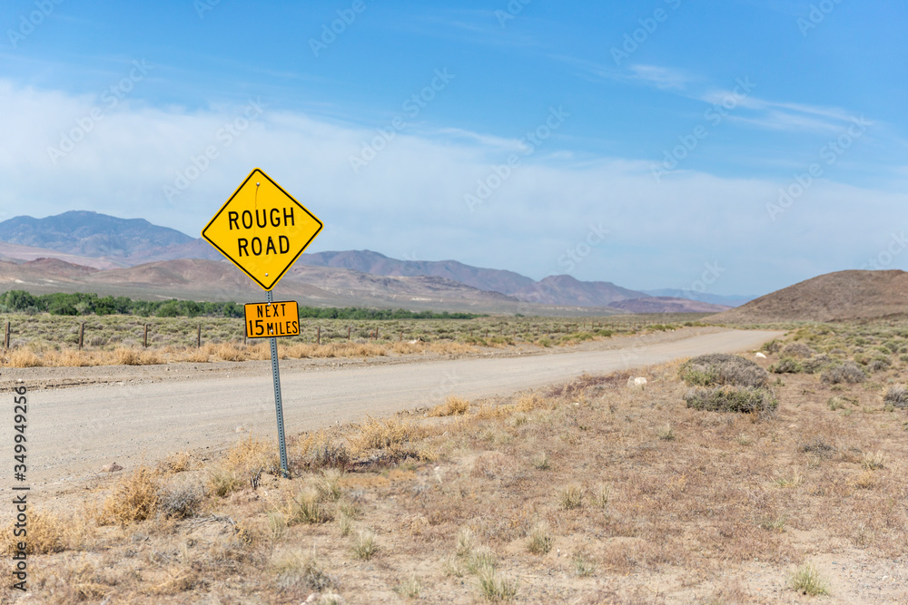Yellow sign warns of rough country road going across the nevada desert