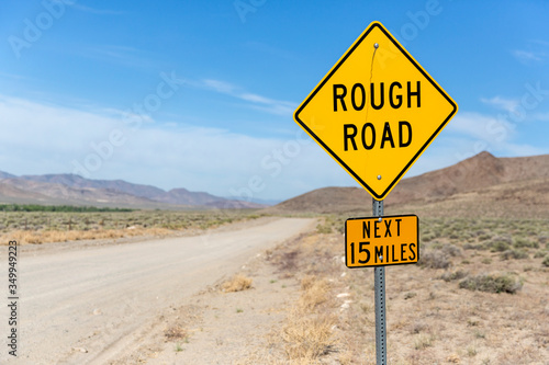 Yellow sign warns of rough country road going across the nevada desert