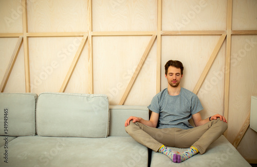 Male with closed eyes sitting in living room