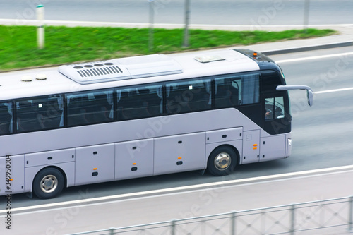 Large comfortable long-distance bus rides on the highway.
