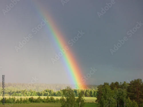 Rainbow over forest Panoramic view Cloudy landscape 