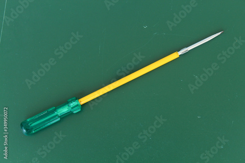 the screwdriver isolated in the green background