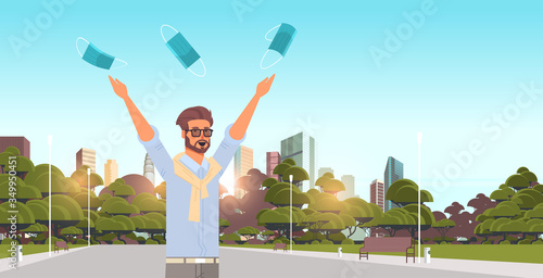 man throwing medical masks coronavirus win defeated covid-19 guy celebrating victory over nCoV virus ending pandemic quarantine concept cityscape background portrait horizontal vector illustration