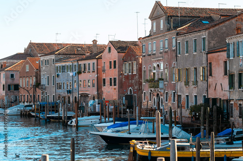 VENICE, ITALY - SEPTEMBER 28, 2018:motor boats docked on canal near ancient buildings in old city of Venice, Italy. © Milena