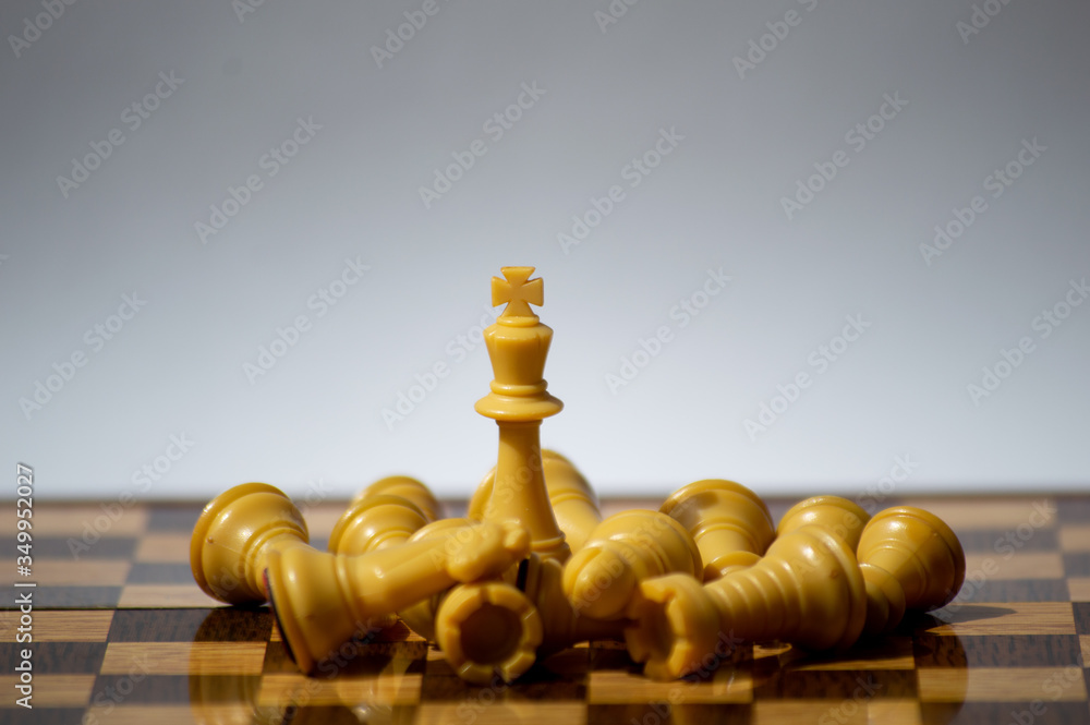 White Knight standing in a set of fallen chess pieces White Knight standing in a set of fallen chess pieces