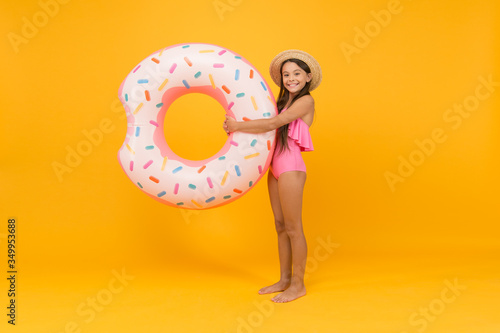 party at the pool. little girl and rubber ring. kid in swimwear at swimming pool. summer water activities. active and energetic vacation. ready for playing and sunbathing. Surfing in the sea