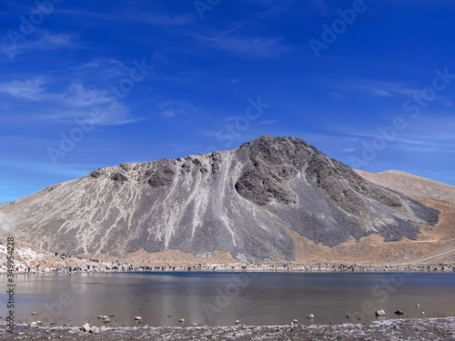 The Nevado de Toluca is a Mexican volcano, located in the state of Mexico at about 4600 meters above sea level, it is one of the four highest mountains in Mexico. Lake and mountain with blue sky. © Gabriela