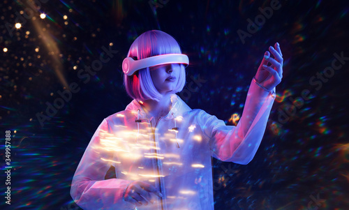 Beautiful woman with purple hair in futuristic costume over neon light background. Girl in glasses of virtual reality. Augmented reality game, future technology, AI concept. VR.