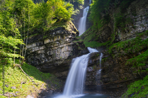 view of the idyllic Diesbach creek waterfall in the Swiss Alps near Braunwald and Glarus in the spring