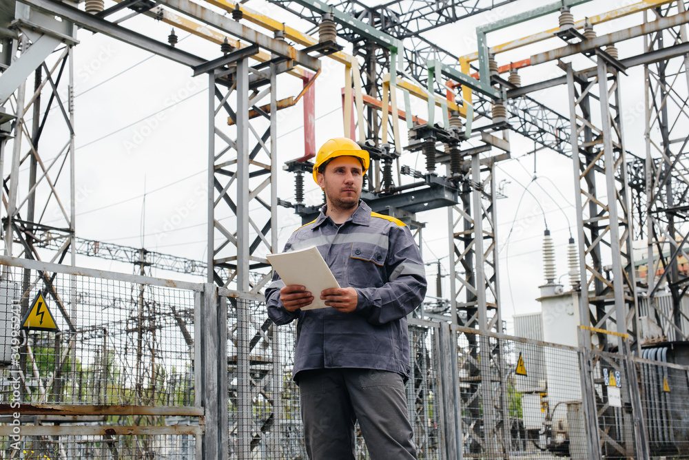 The energy engineer inspects the equipment of the substation. Power engineering. Industry