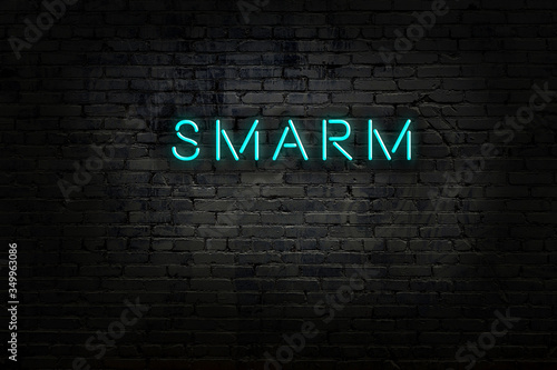 Neon sign with inscription smarm against brick wall photo