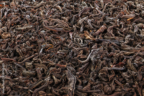 Dried Tea Leaves. The texture of large leaf black tea. Closeup. Full depth of field.