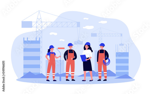 Team of builders onsite. Female engineer, architect, technician, worker in overalls holding tools, discussing work. Can be used for construction site, engineering, teamwork concept
