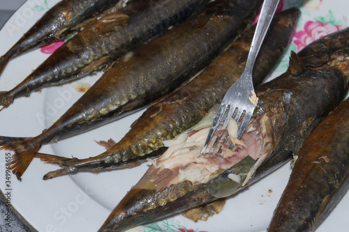 Smoked fresh fish mackerel lies hot on a ceramic plate