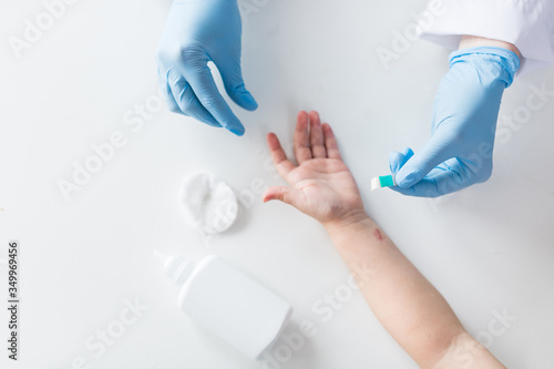 doctor puts a Band-Aid on his hand