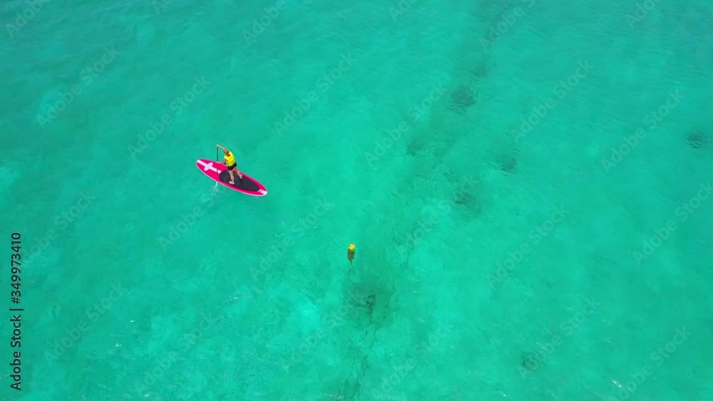 Paddle Boarder on Caribbean Ocean Cayman Islands Aerial View Paddle Boarder on Caribbean Ocean Cayman Islands Aerial View