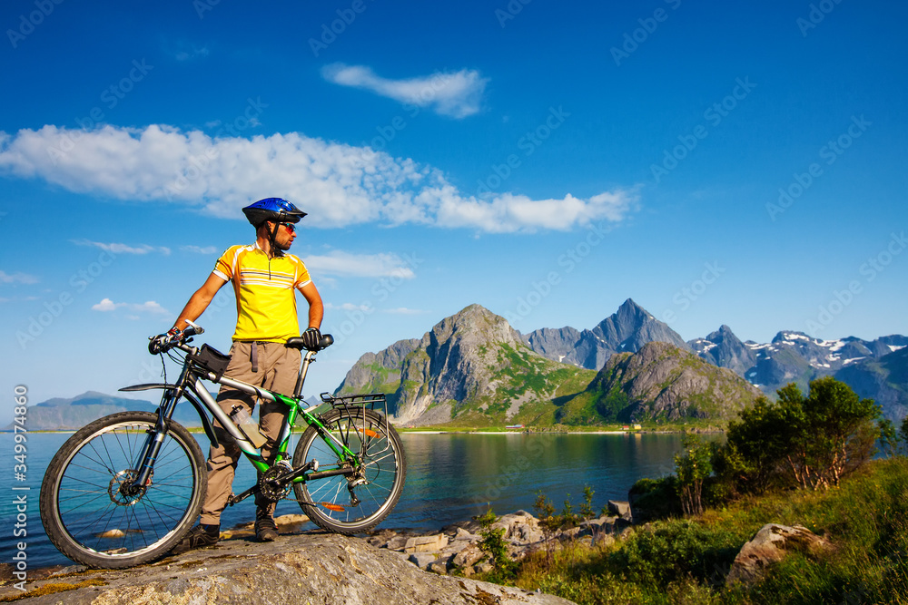 Biking in Norway against picturesque landscape. Bike, active.