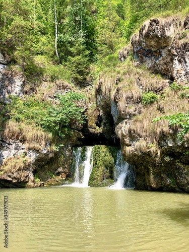 Fototapeta Naklejka Na Ścianę i Meble -  Waterfall Beautiful emerald underground lake in the Ural mountains of the Republic of Bashkortostan, Atysh river