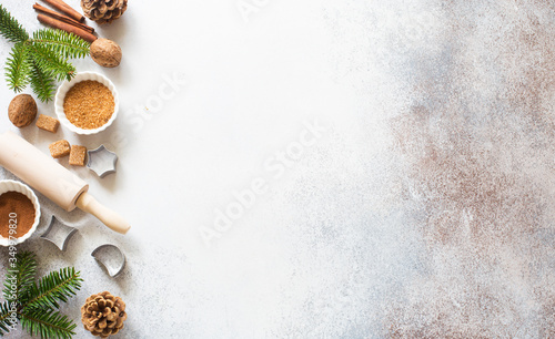 Christmas and New Year background with baking ingredients, cones and fir twigs photo