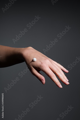 Hand of a woman applying cream