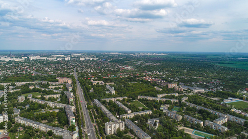 Aerial view of small city buidings and fields in Ukraine.Top down summer city view of Kharkov city near the town. Urban and landmarks concept