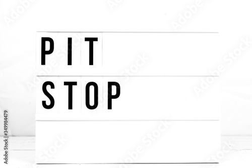 Modern Pit Stop Sign on Retro Quote Board.