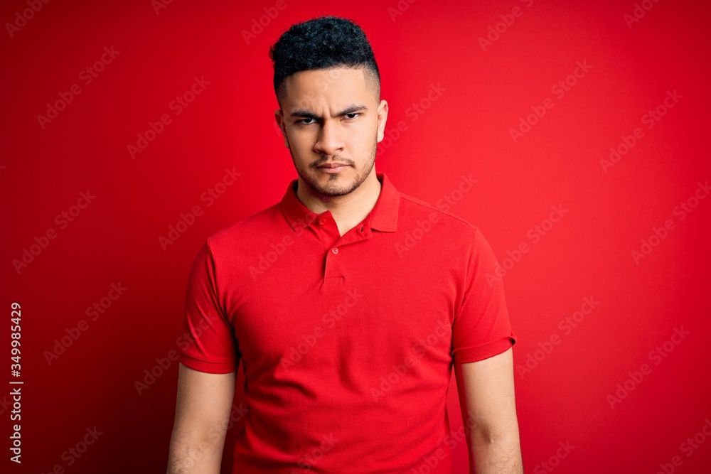 Young handsome man wearing red casual polo standing over isolated background skeptic and nervous, frowning upset because of problem. Negative person. Young handsome man wearing red casual polo standing over isolated background skeptic and nervous, frowning upset because of problem. Negative person.