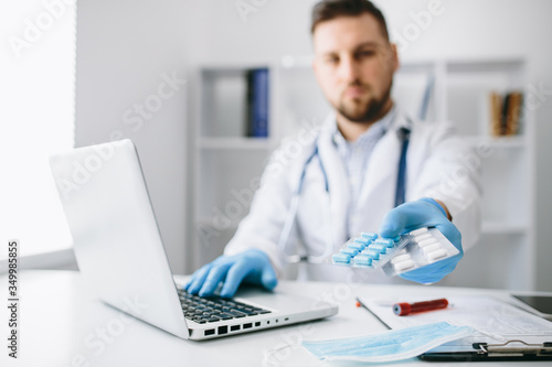 Doctor In White Coat On Shoulder in cabinet write recipe for patient. Healthcare Medical Hospital Concept