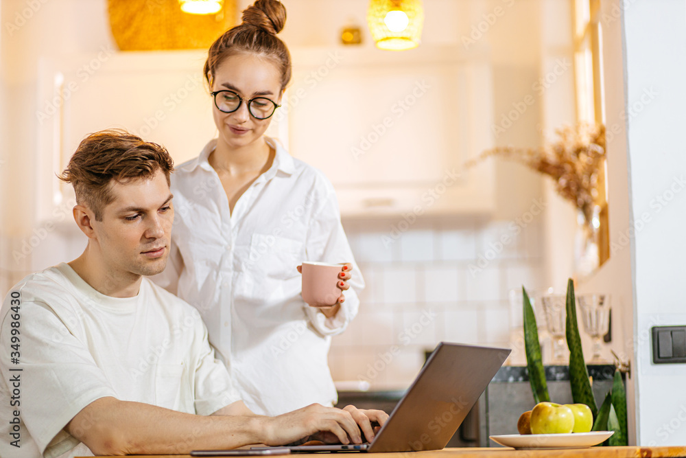 confident married couple want to buy their first property, they look at laptop, looking for new apartment online on the site, surfing the Net. ain domestic clothes t home confident married couple want to buy their first property, they look at laptop, looking for new apartment online on the site, surfing the Net. ain domestic clothes t home