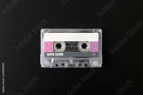 Old tape cassette, old or aged wood background. İsolated casette