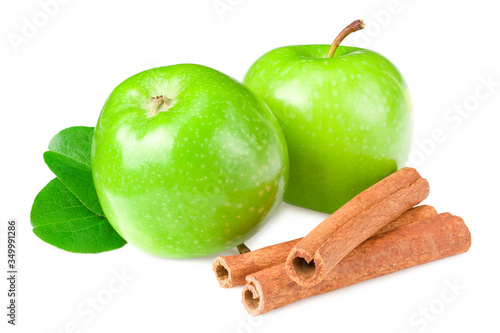 green apples with green leaves and cinnamon isolated on white background