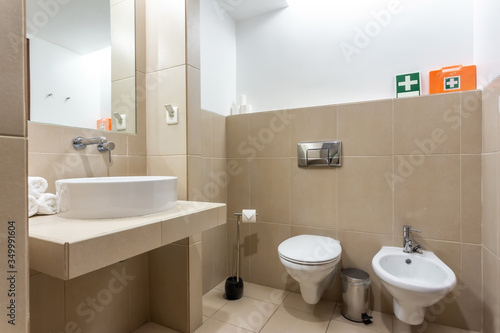 Modern bathroom with bathtub  mirror and washbasin. European hotel design.