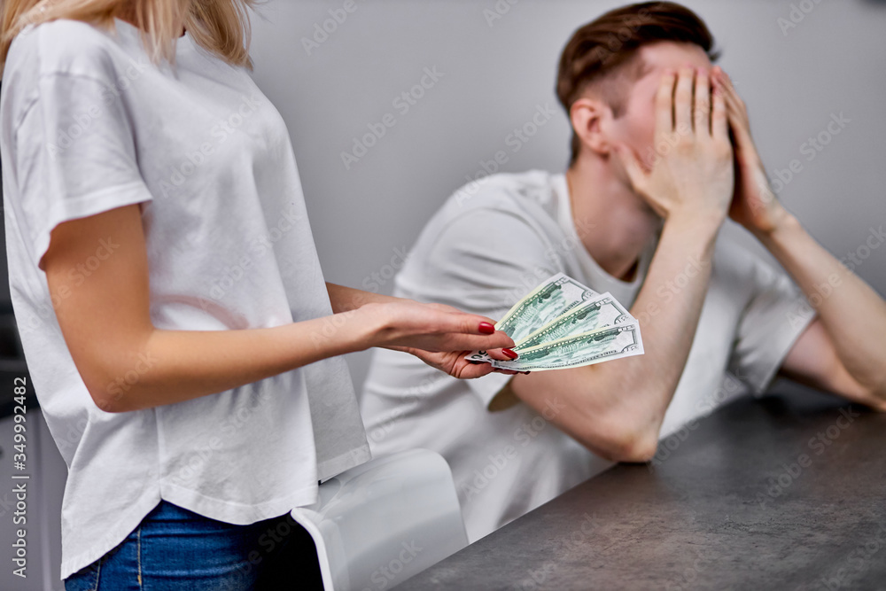 Fototapeta premium wife outraged why husband brings so little money in a family wallet, she expresses dissatisfaction with husband's working capacity, man close face with hands