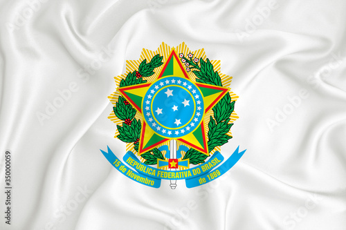 A developing white flag with the coat of arms of Brazil. Country symbol. Illustration. Original and simple coat of arms in official colors and the right proportion