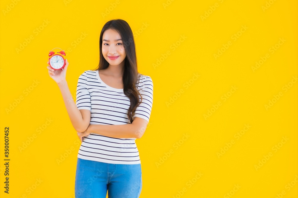 Portrait beautiful young asian woman show clock or alarm Portrait beautiful young asian woman show clock or alarm