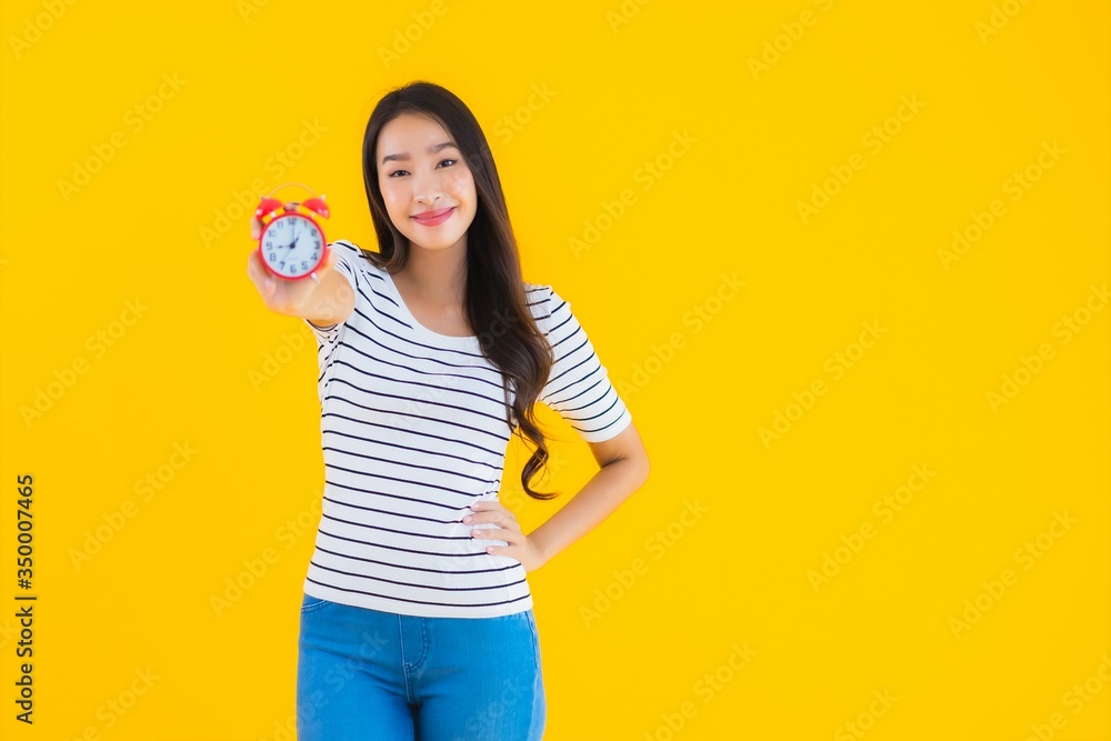 Portrait beautiful young asian woman show clock or alarm Portrait beautiful young asian woman show clock or alarm