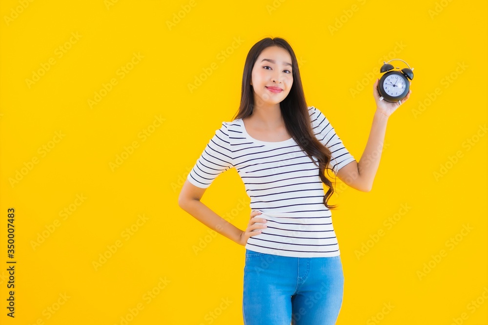 Portrait beautiful young asian woman show clock or alarm Portrait beautiful young asian woman show clock or alarm