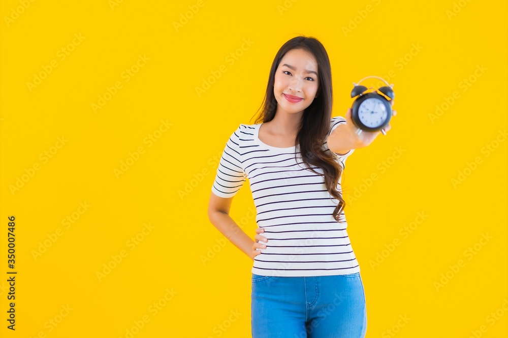 Portrait beautiful young asian woman show clock or alarm Portrait beautiful young asian woman show clock or alarm