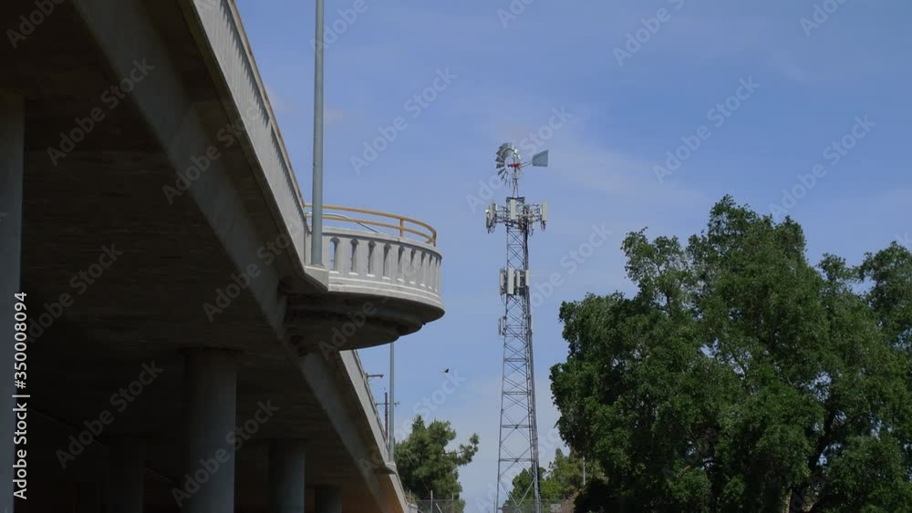 Looking up at a bridge with swallows nesting and a windmill spinning Looking up at a bridge with swallows nesting and a windmill spinning