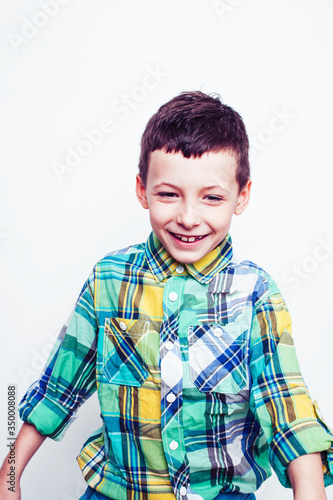 little cute real boy on white background gesture smiling close up, lifestyle people concept