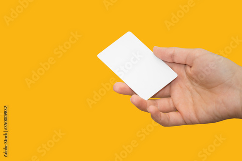 female hand holding bank card with colorful background photo